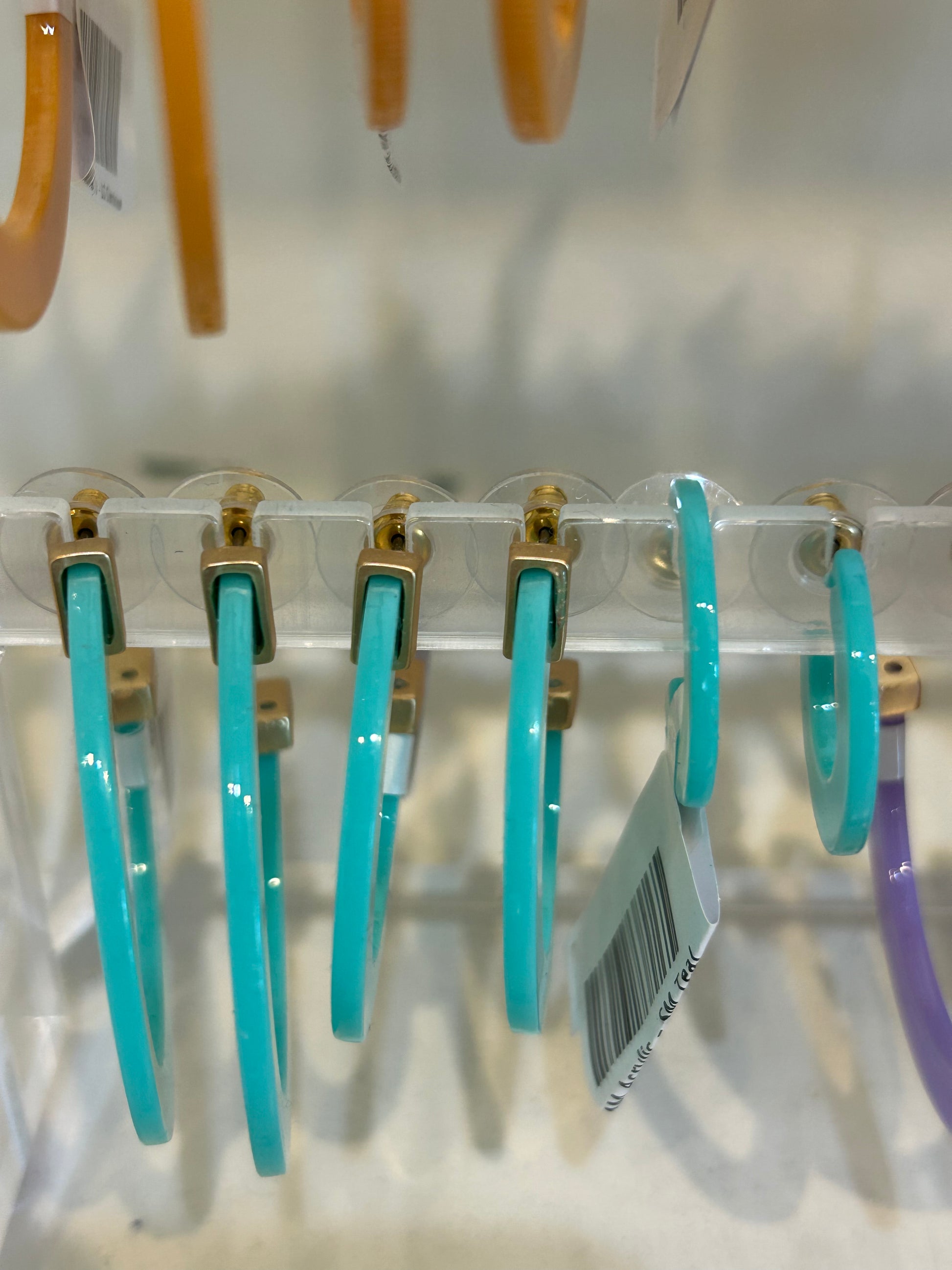 Turquoise acrylic hoop earrings in three sizes.
