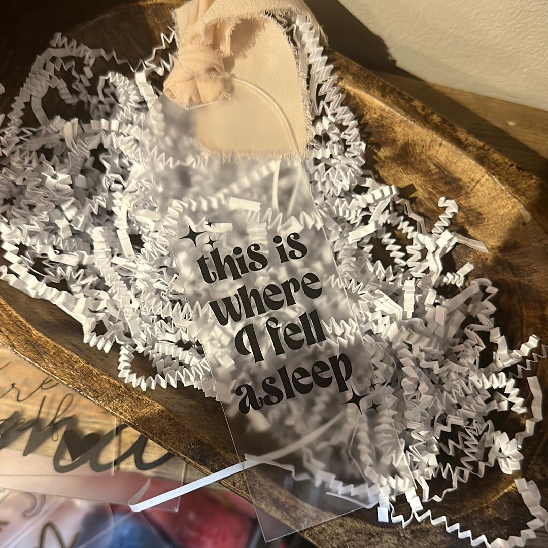 Clear acrylic bookmark with black lettering featuring "This is where I fell asleep".