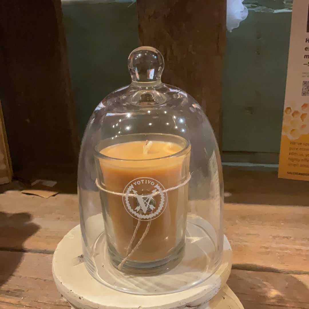 Candle in glass votive with a glass dome.