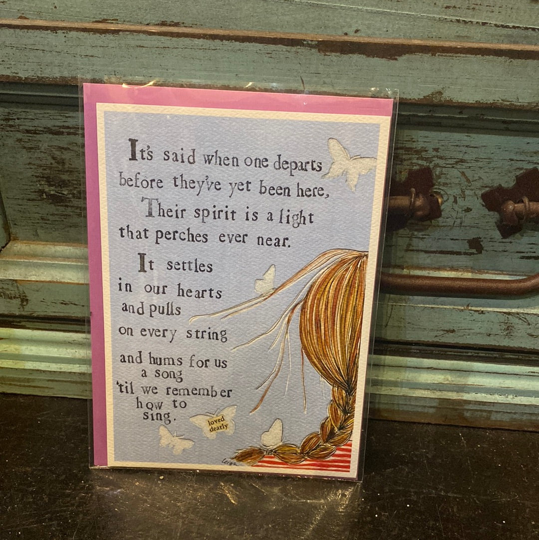 Card with a girl with a braid displaying "It’s said when one departs before they’ve yet been here, Their spirit is a light that perches ever near. It settles in our hearts and pulls on every string and hums for us a song ‘til we remember how to sing.”