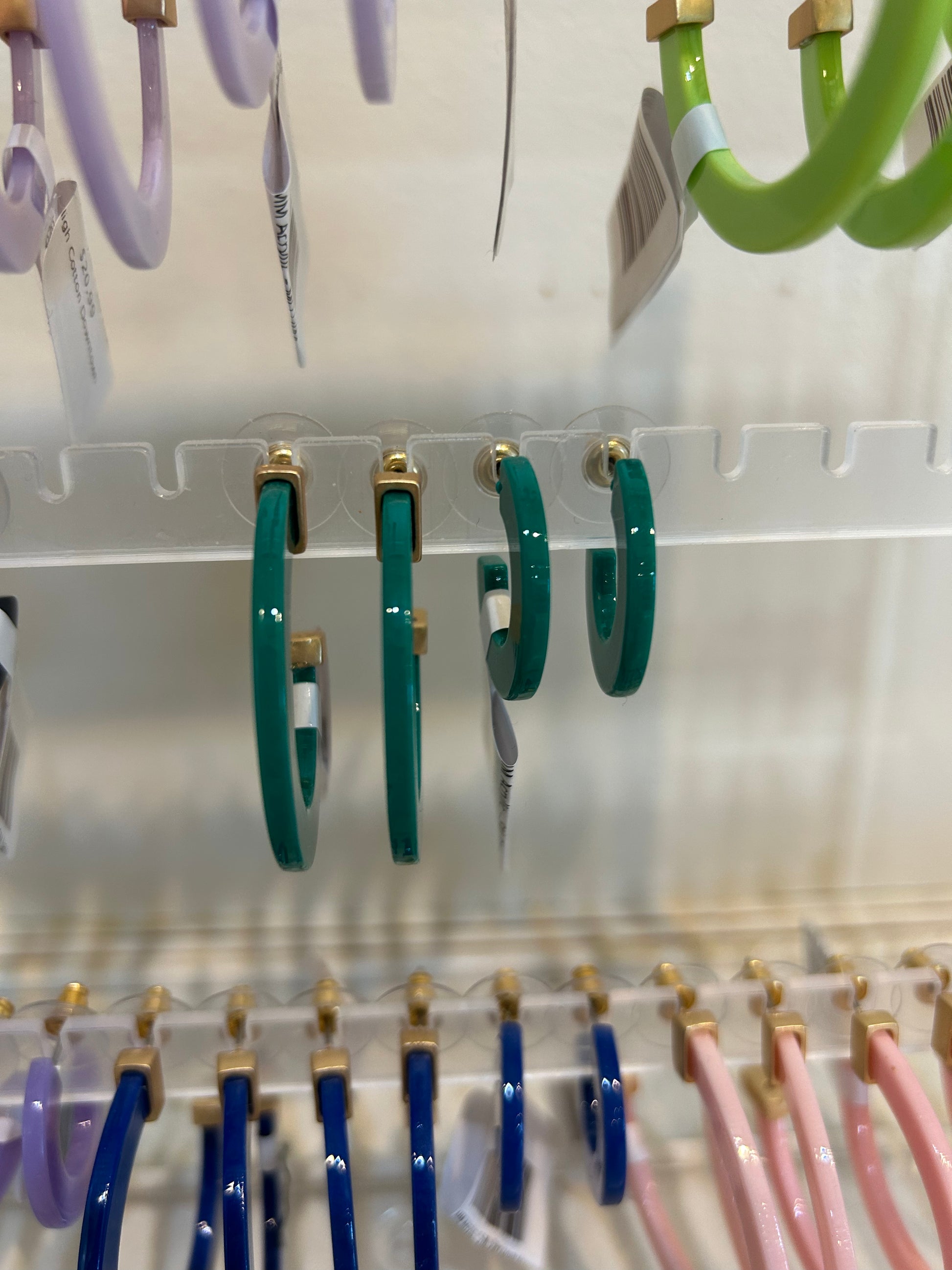 Dark green acrylic hoop earrings.