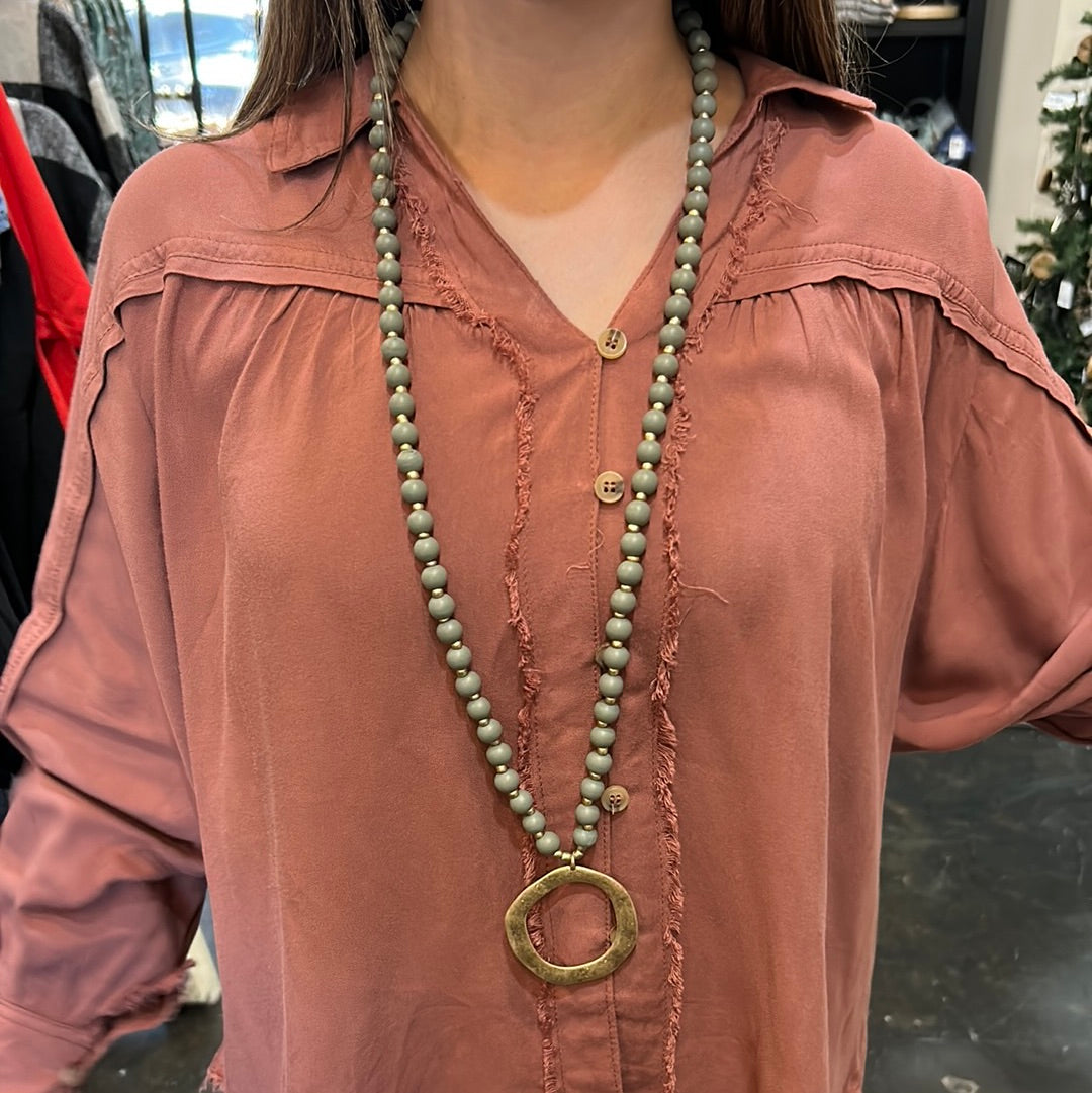 Gray Wood Beaded Necklace with Golden round Charm.