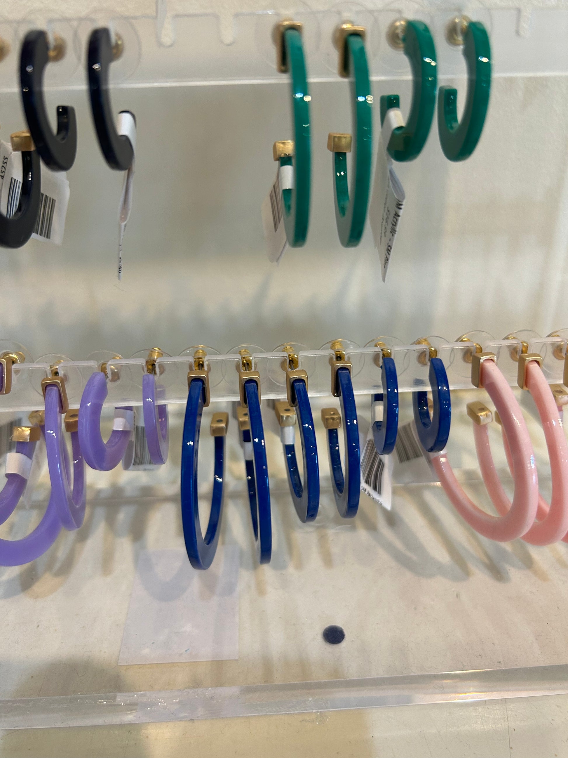 Royal blue acrylic hoop earrings in three sizes.