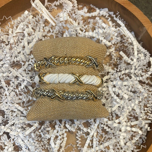 Assorted mixed metal bracelets.