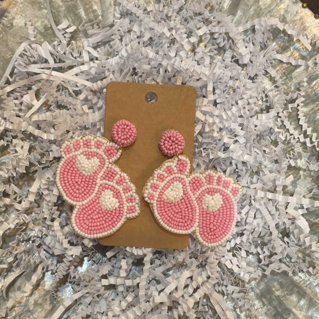 Beaded pink foot earrings.