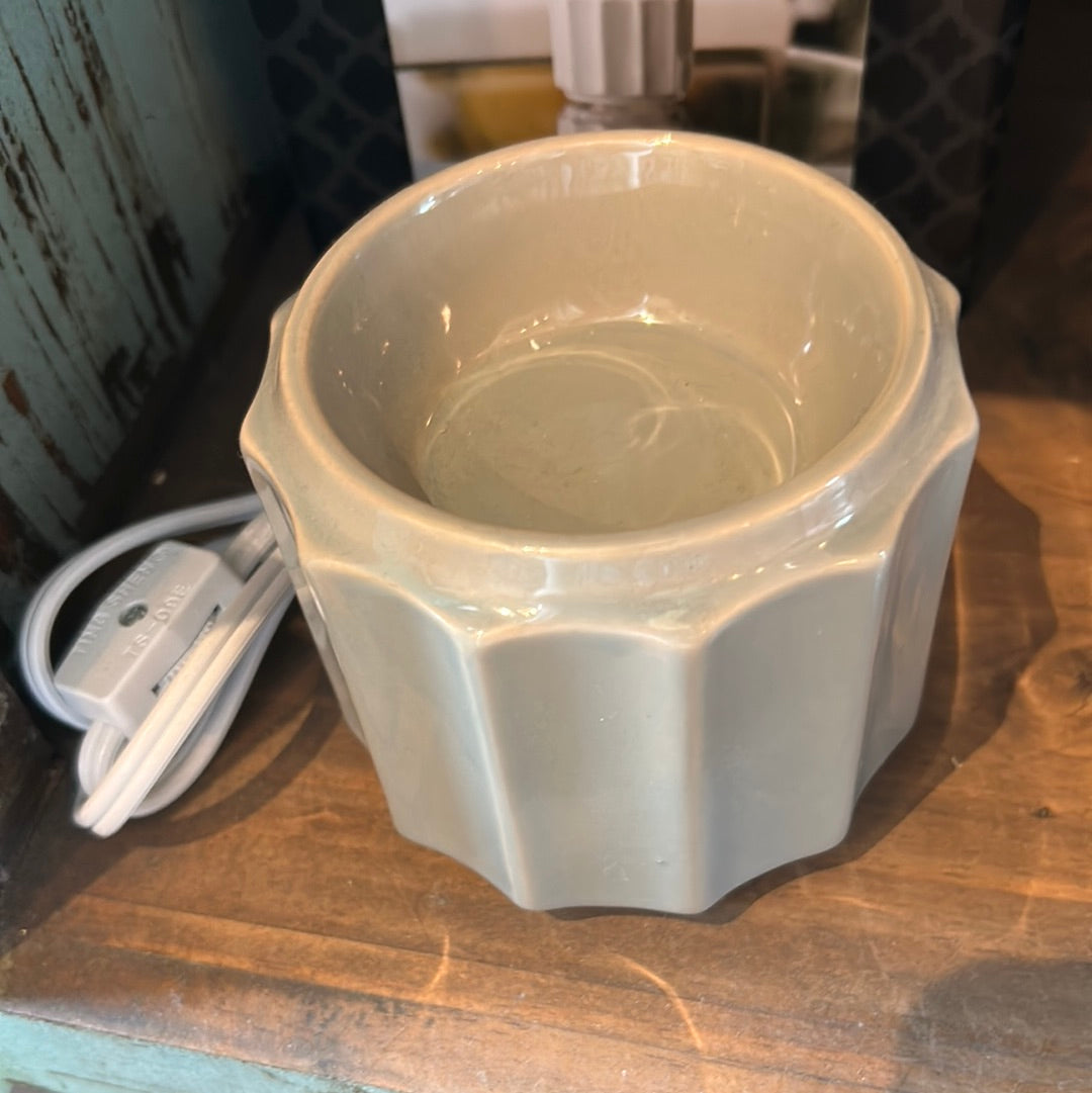 Gray ceramic wax warmer with plug.