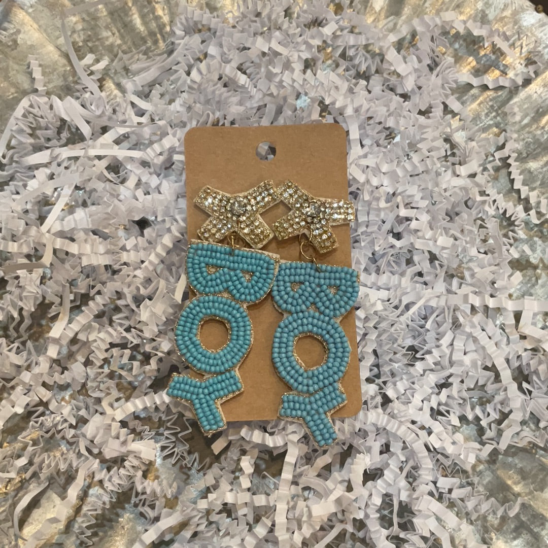 Blue beaded earrings featuring "BOY" dangle with tan beaded bows.