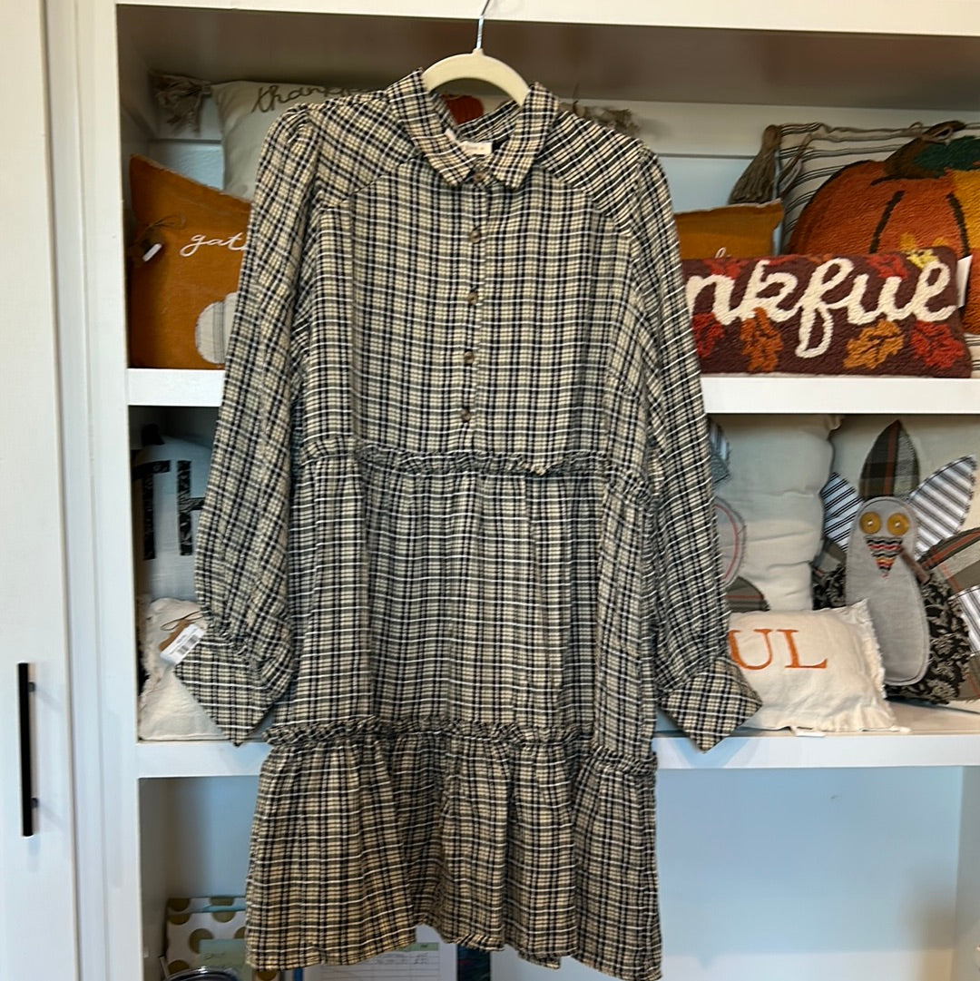 Black colored flannel plaid tiered dress with long sleeves.