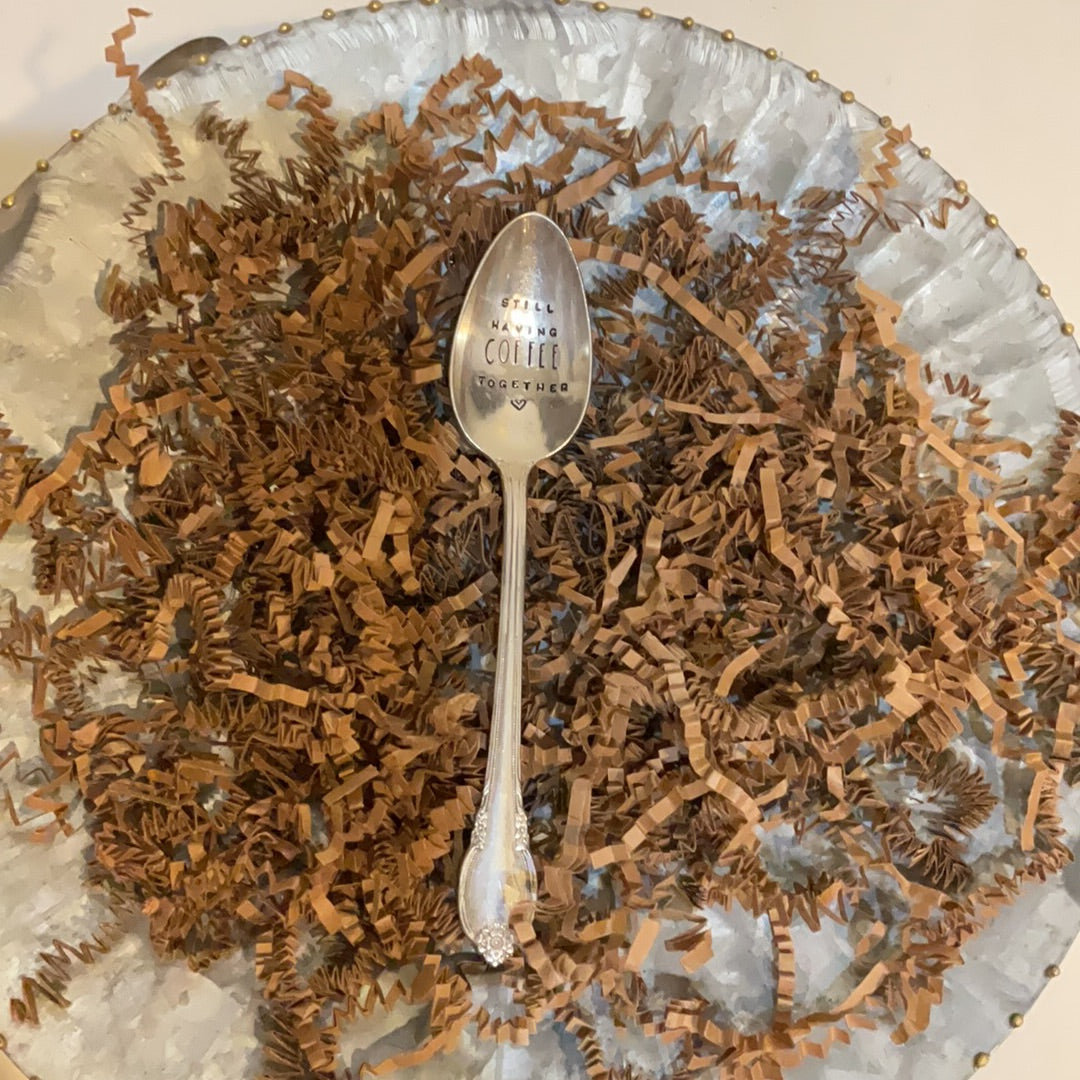 Engraved teaspoon featuring "Still having coffee together".