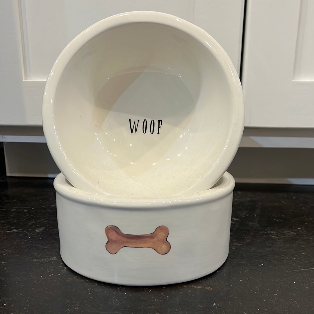 White ceramic dog food bowls featuring "woof" & a bone.