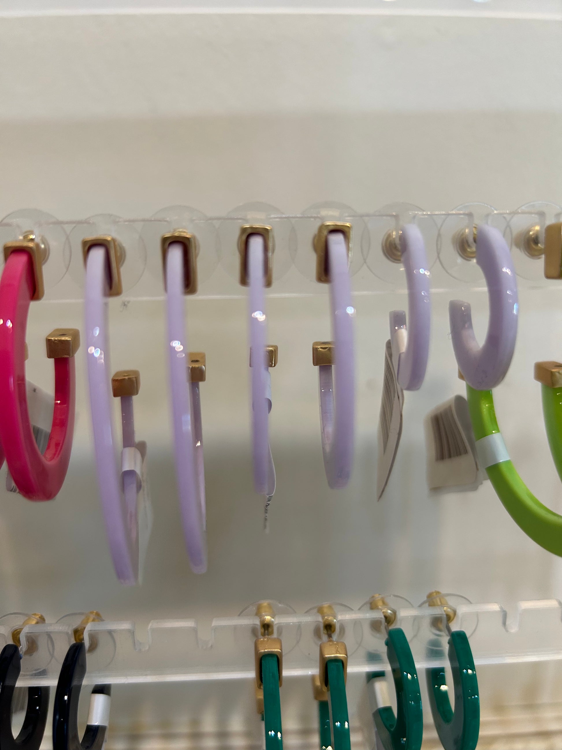 Light purple acrylic hoop earrings in three sizes.