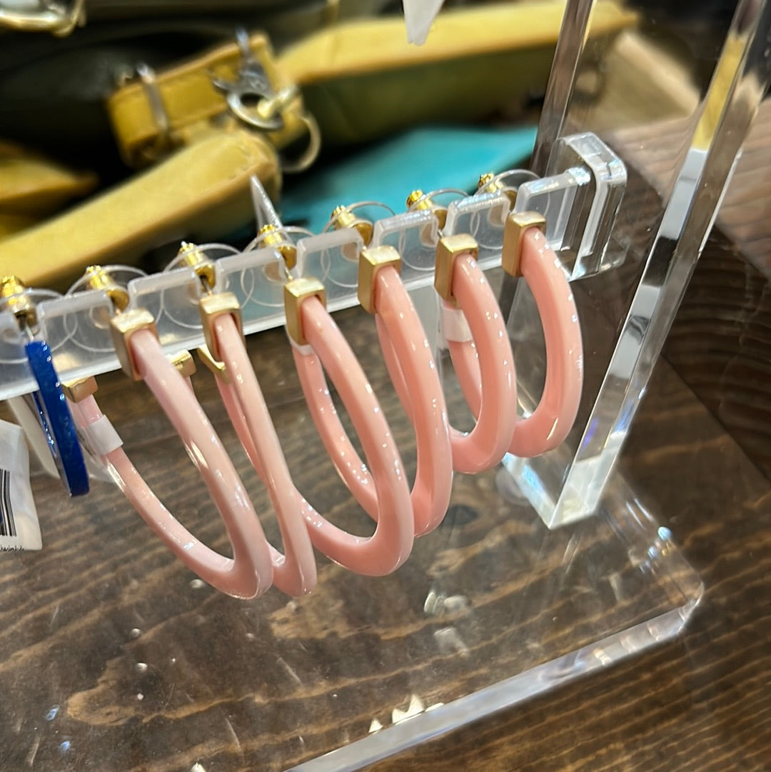 Pal pink acrylic hoop earrings in three sizes.