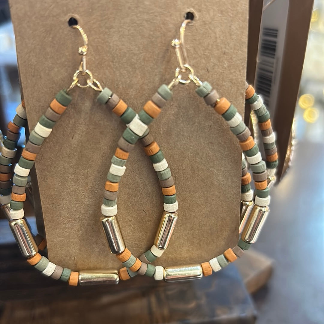 Open teardrop shaped earrings with light wooden and golden beads.