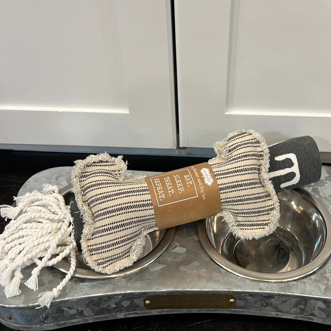 Canvas dog blanket featuring "EAT. SLEEP. TREAT. REPEAT" with a canvas dog bone toy.