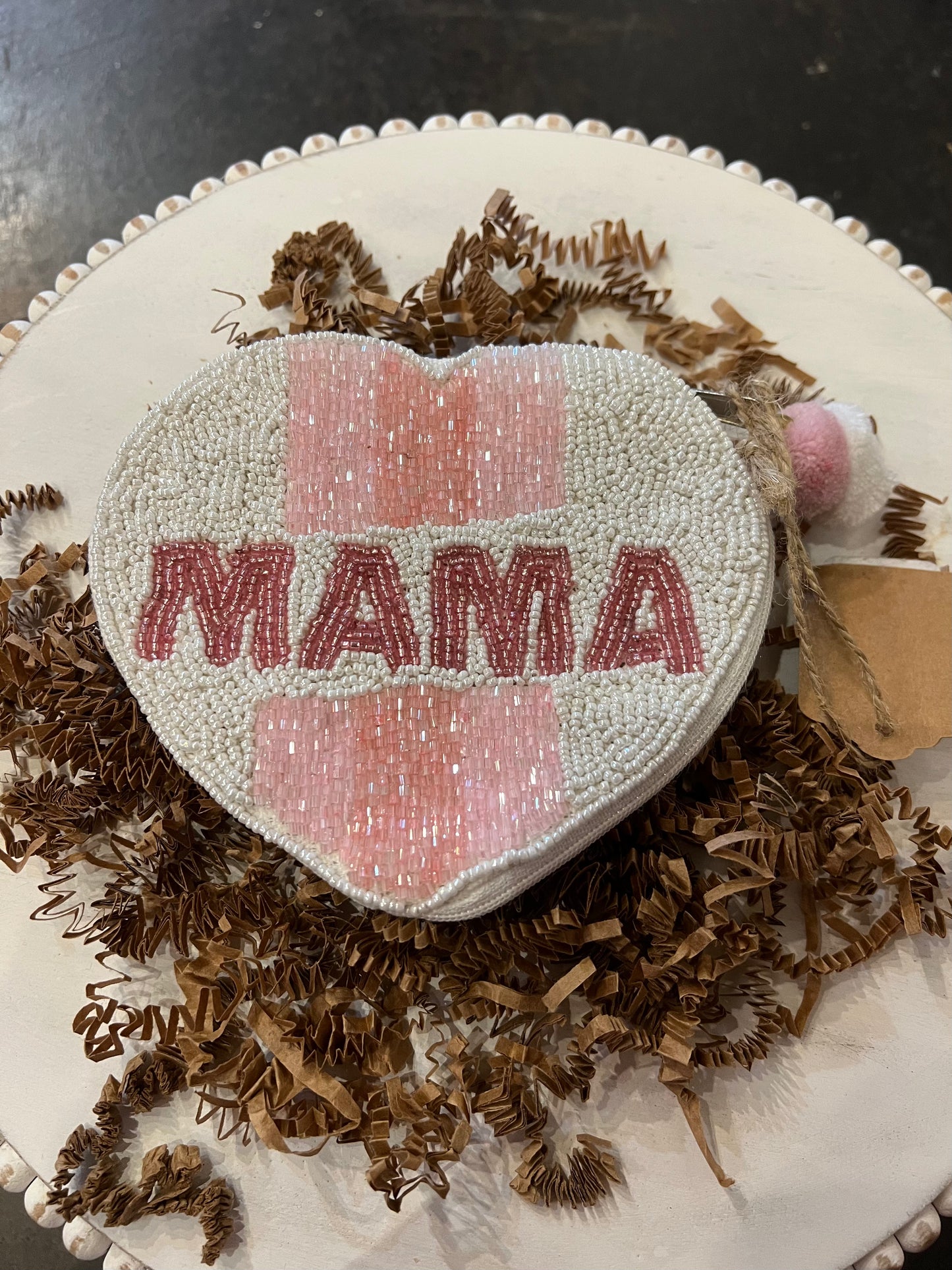 White heart shaped beaded coin bag featuring "MAMA" in pink beading.