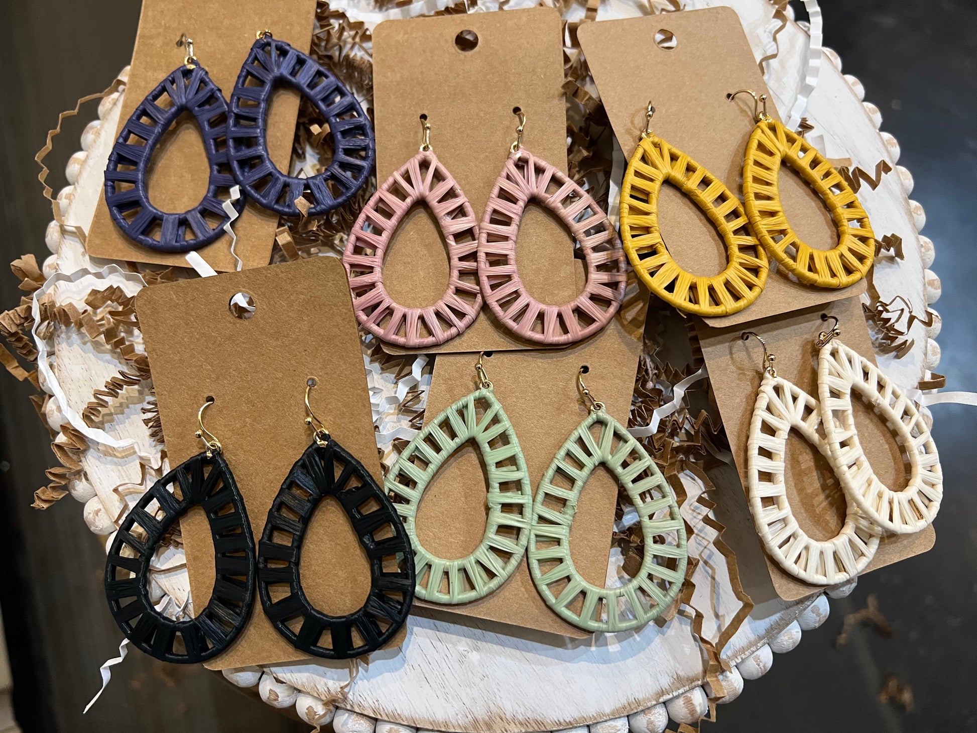 Assorted raffia wrapped teardrop earrings.