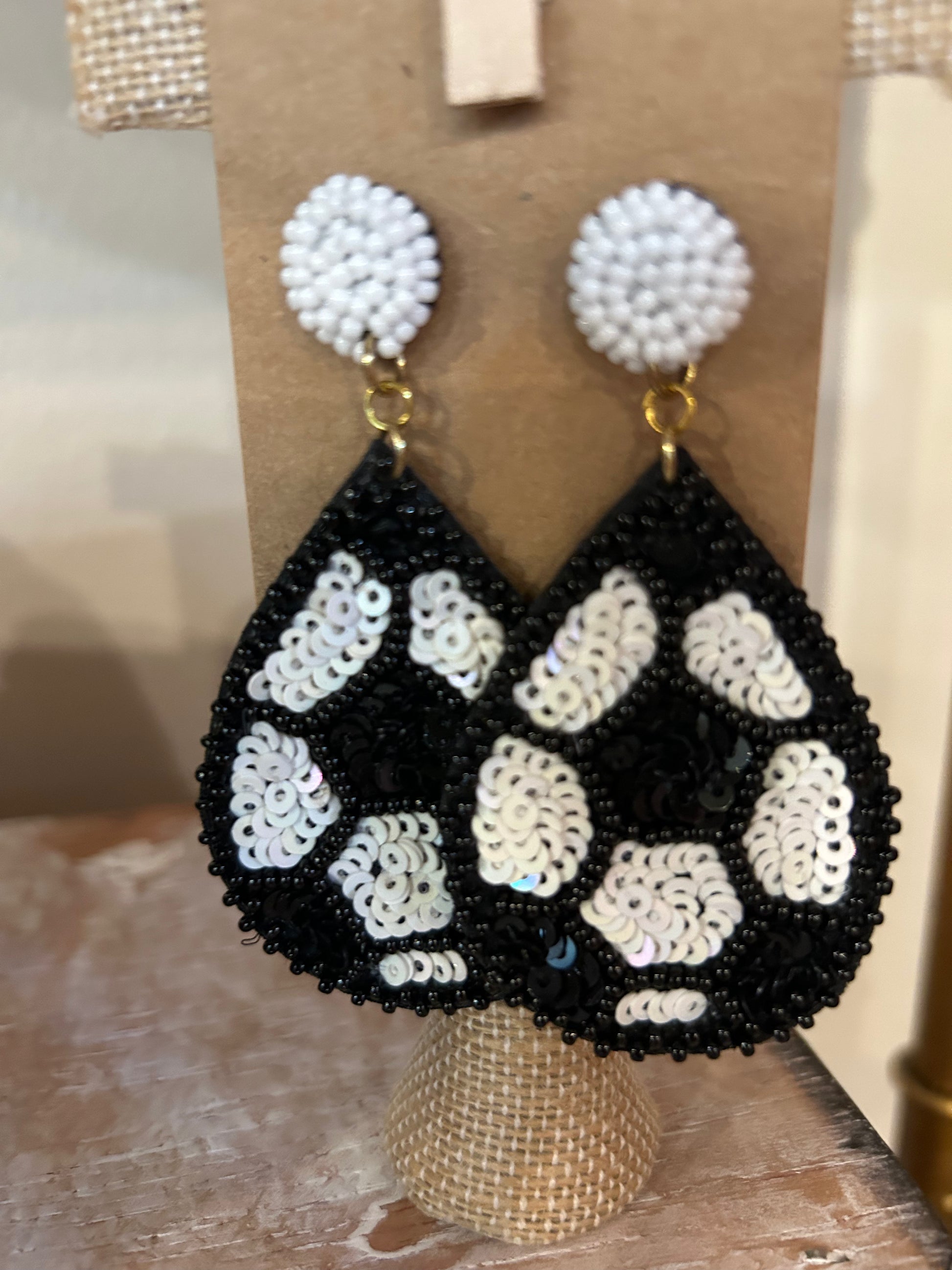 White beaded stud with teardrop shaped soccer ball dangle.
