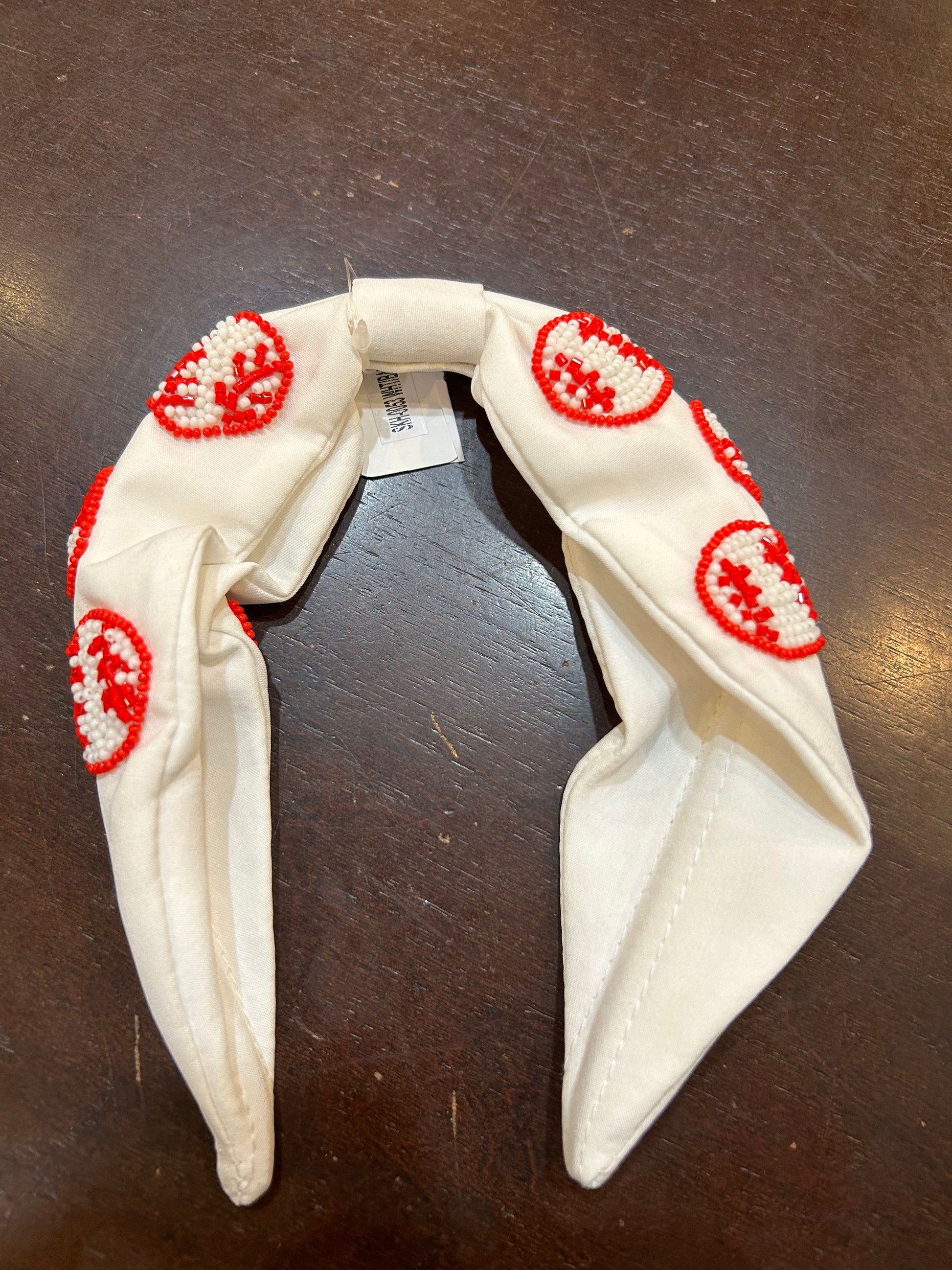 White headband with red and white beaded baseballs.