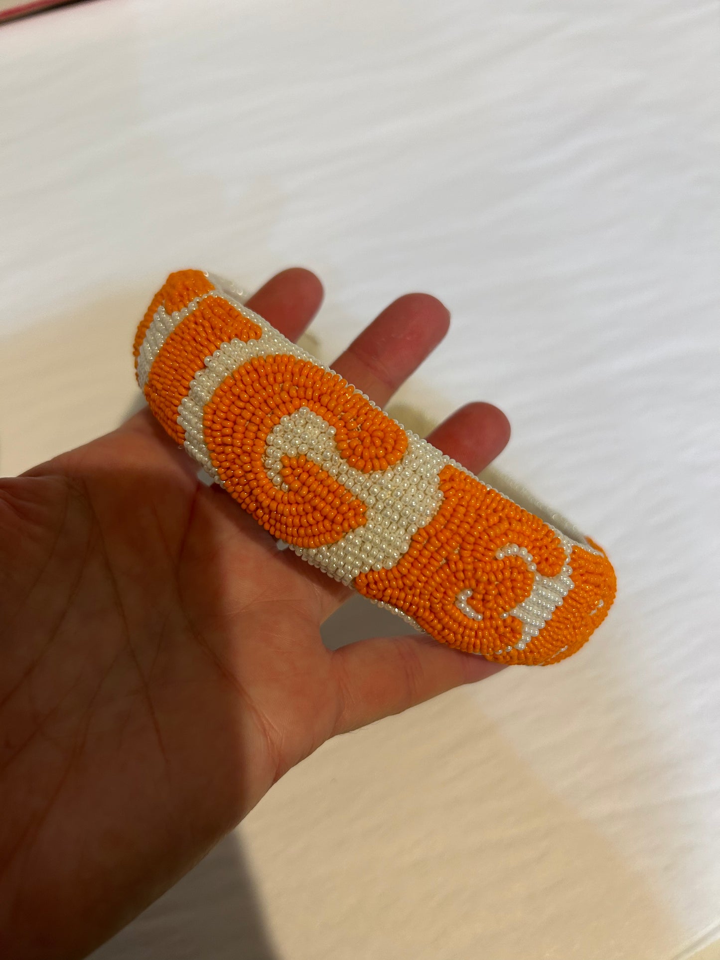 Orange and white beaded headband with "TIGERS".