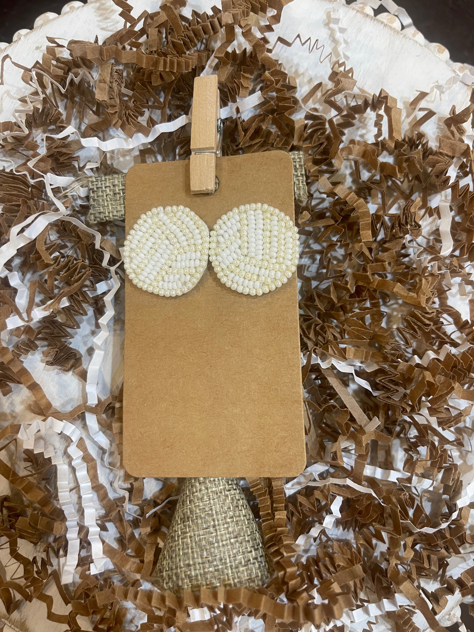 White beaded volleyball stud earrings.