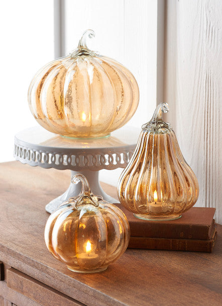 Assorted decorative glass pumpkin with orange hues.