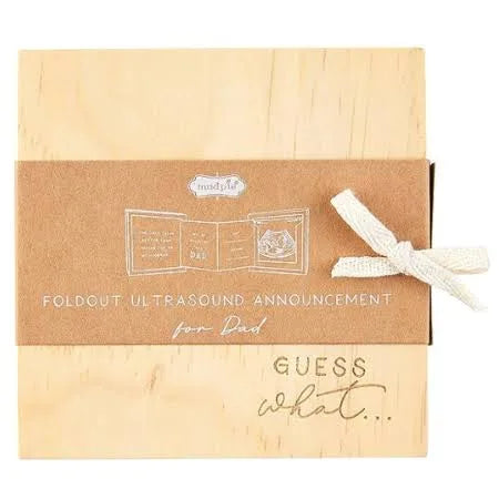 Wooden ultrasound announcement displaying "GUESS what..."
