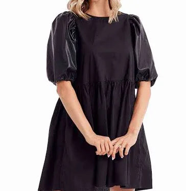 Model featuring black dress with leather puff sleeves.