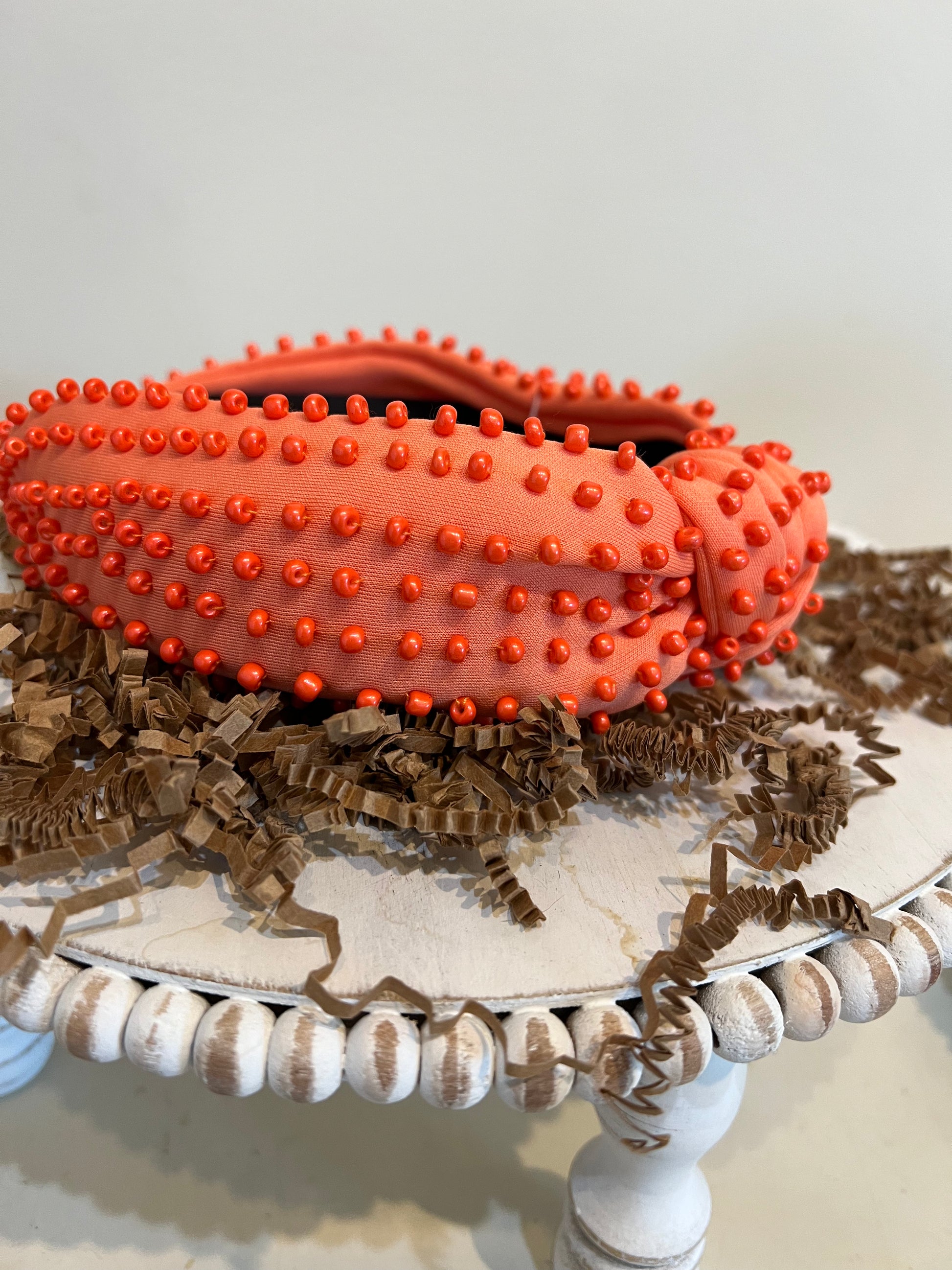 Orange top knot headband with orange beads.