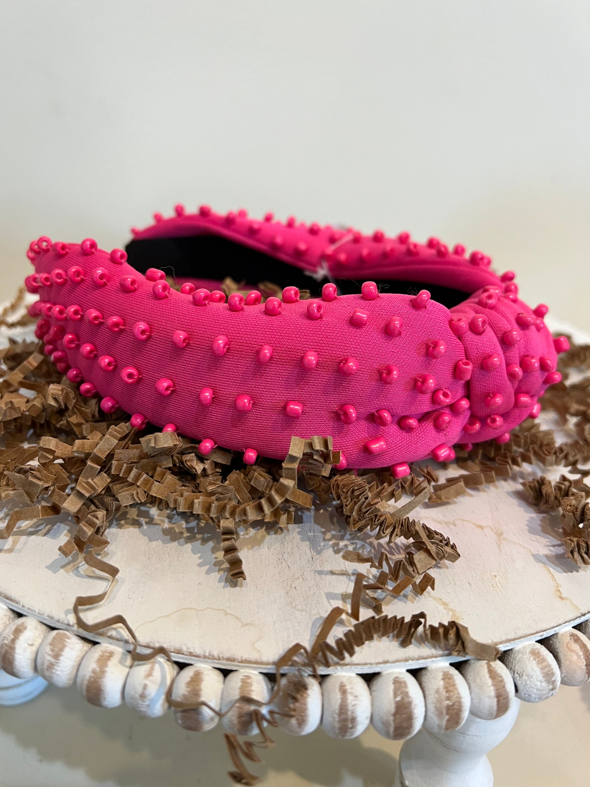 Pink top knot headband with pink beads.