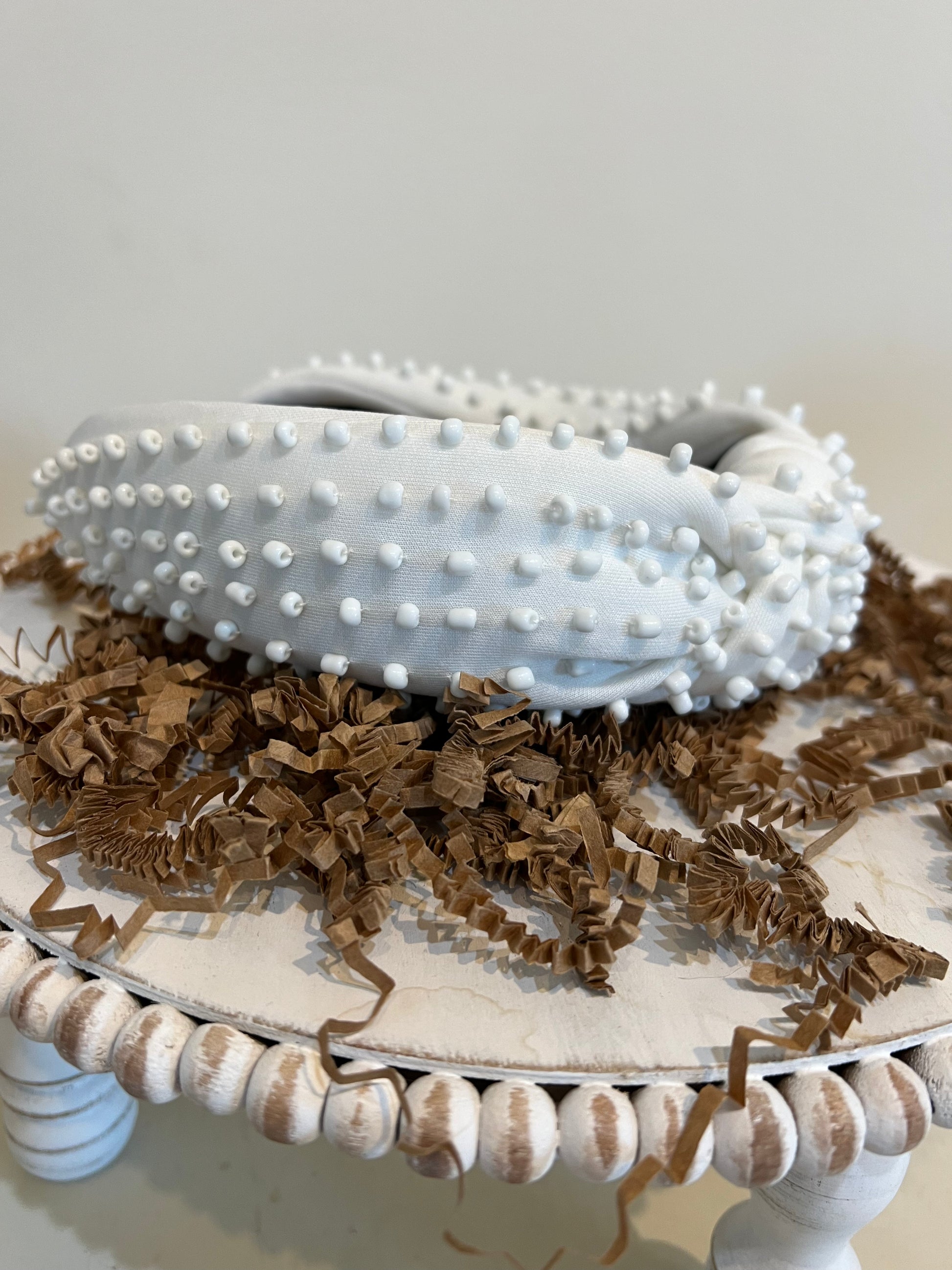 White top knot headband with white beads.