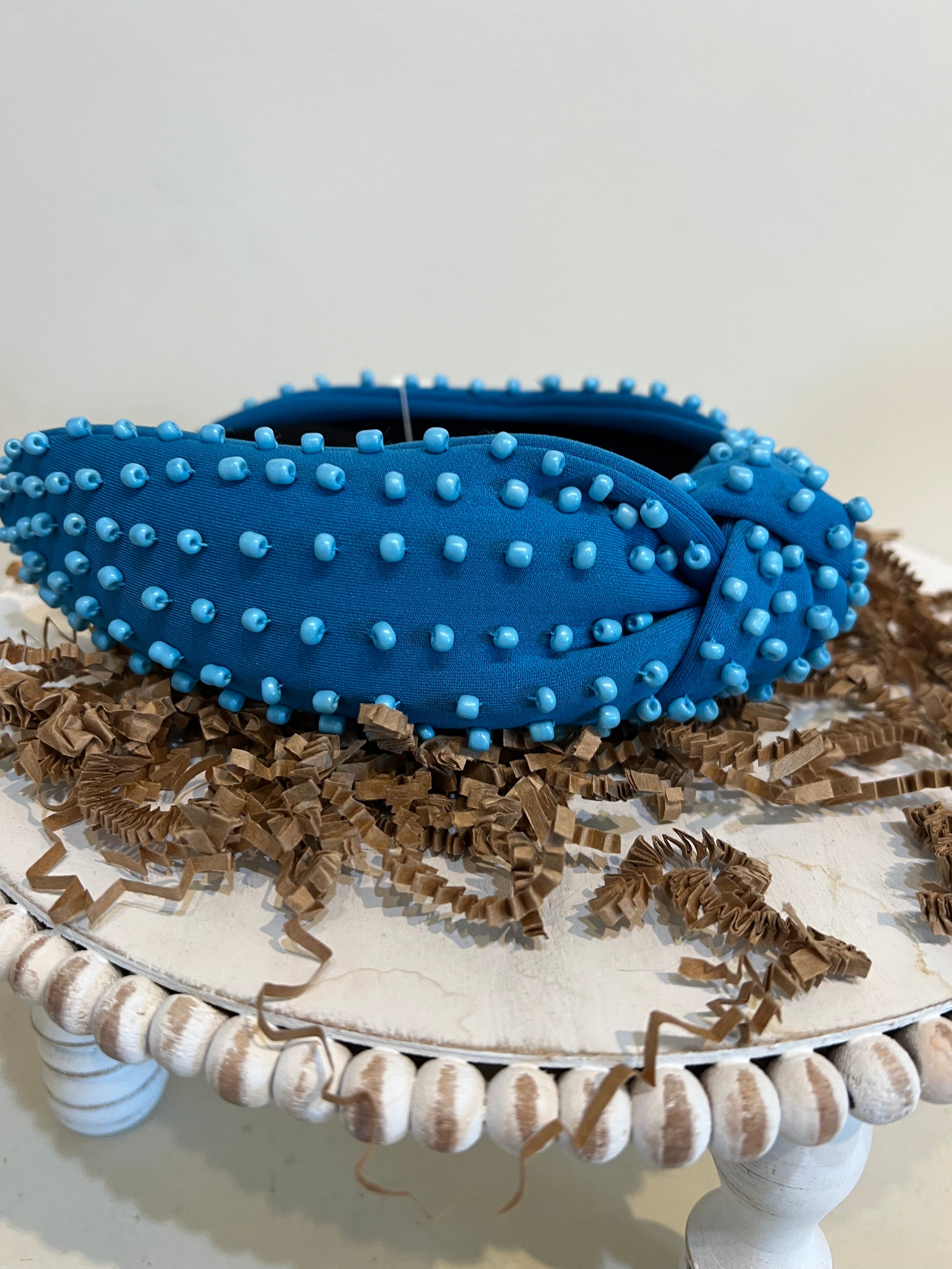 Blue top knot headband with blue beads.