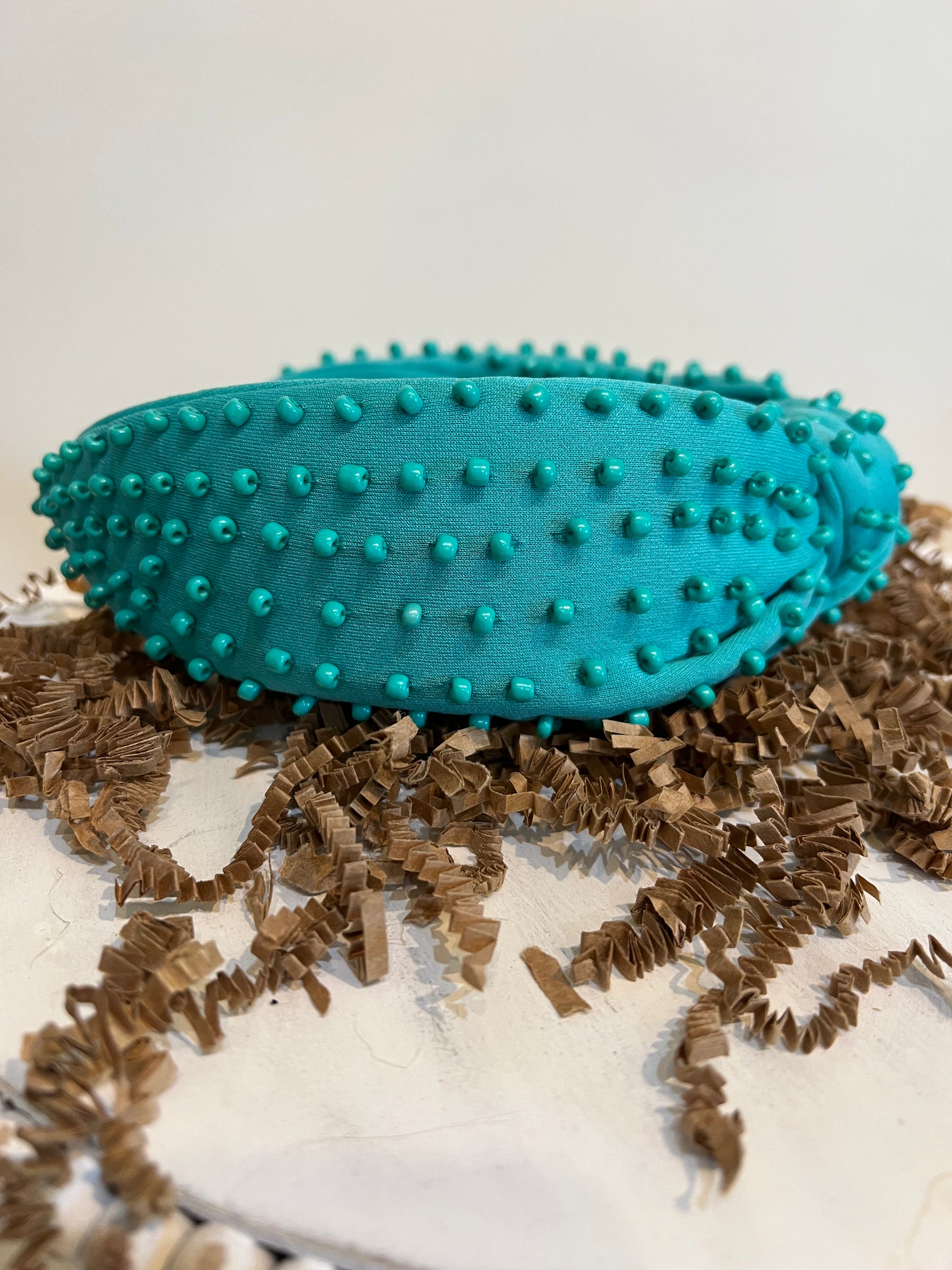 Green top knot headband with green beads.