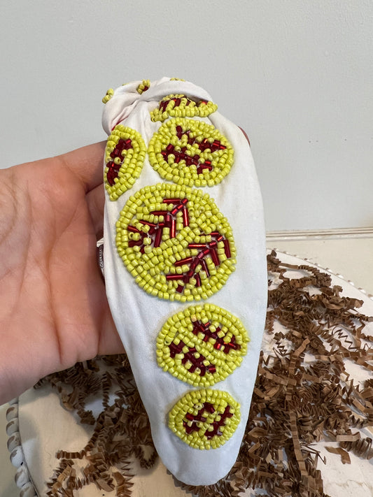 White topknot headband with neon yellow beaded softballs.