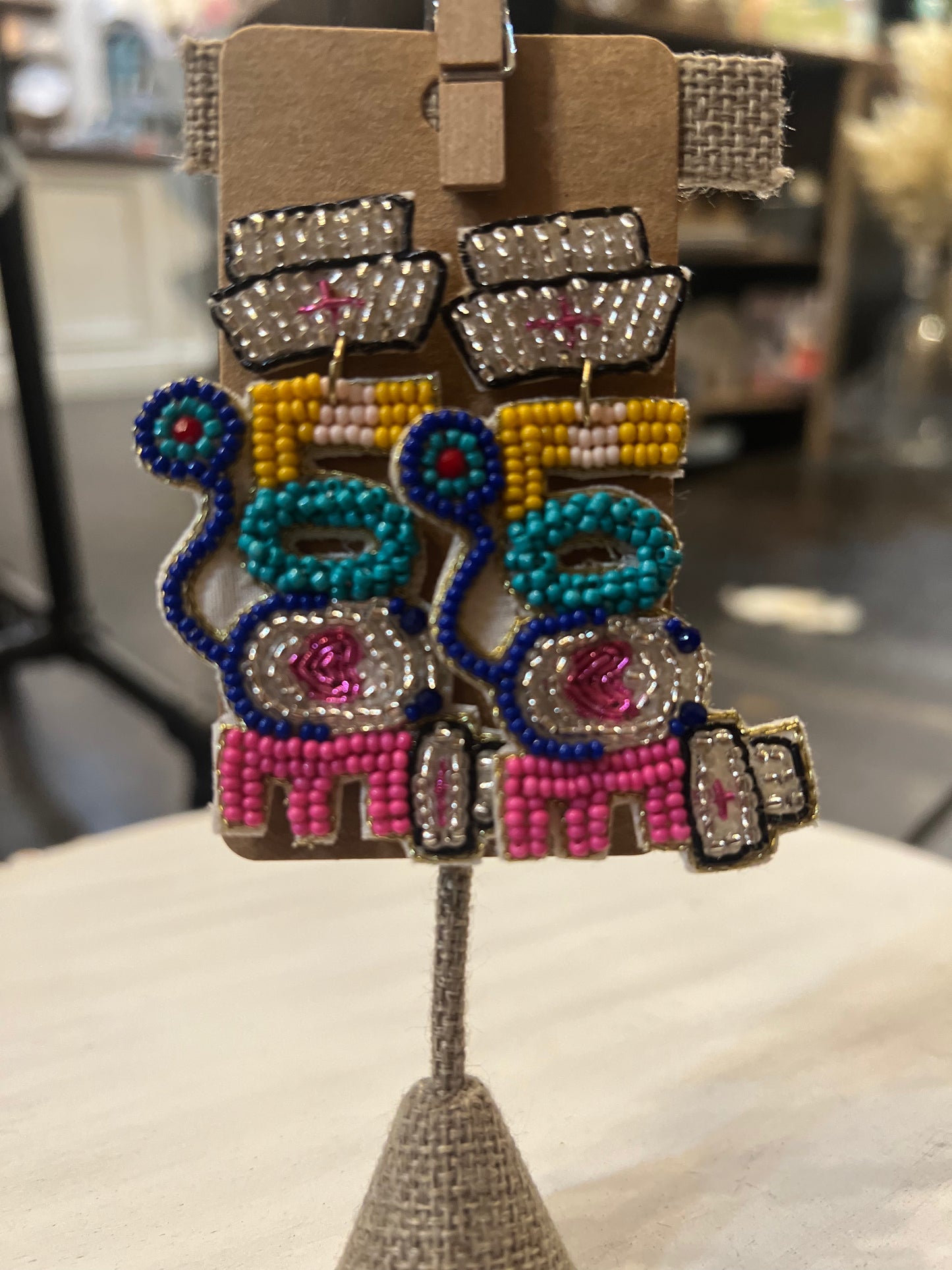 Beaded dangle earrings featuring "love" with icons of nursing.