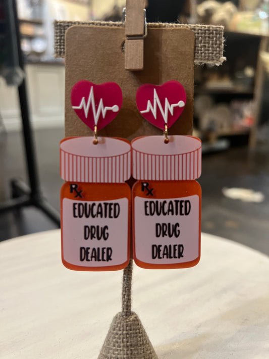 Orange pill bottle earrings displaying "Educated Drug Dealer" with heartbeat stud.