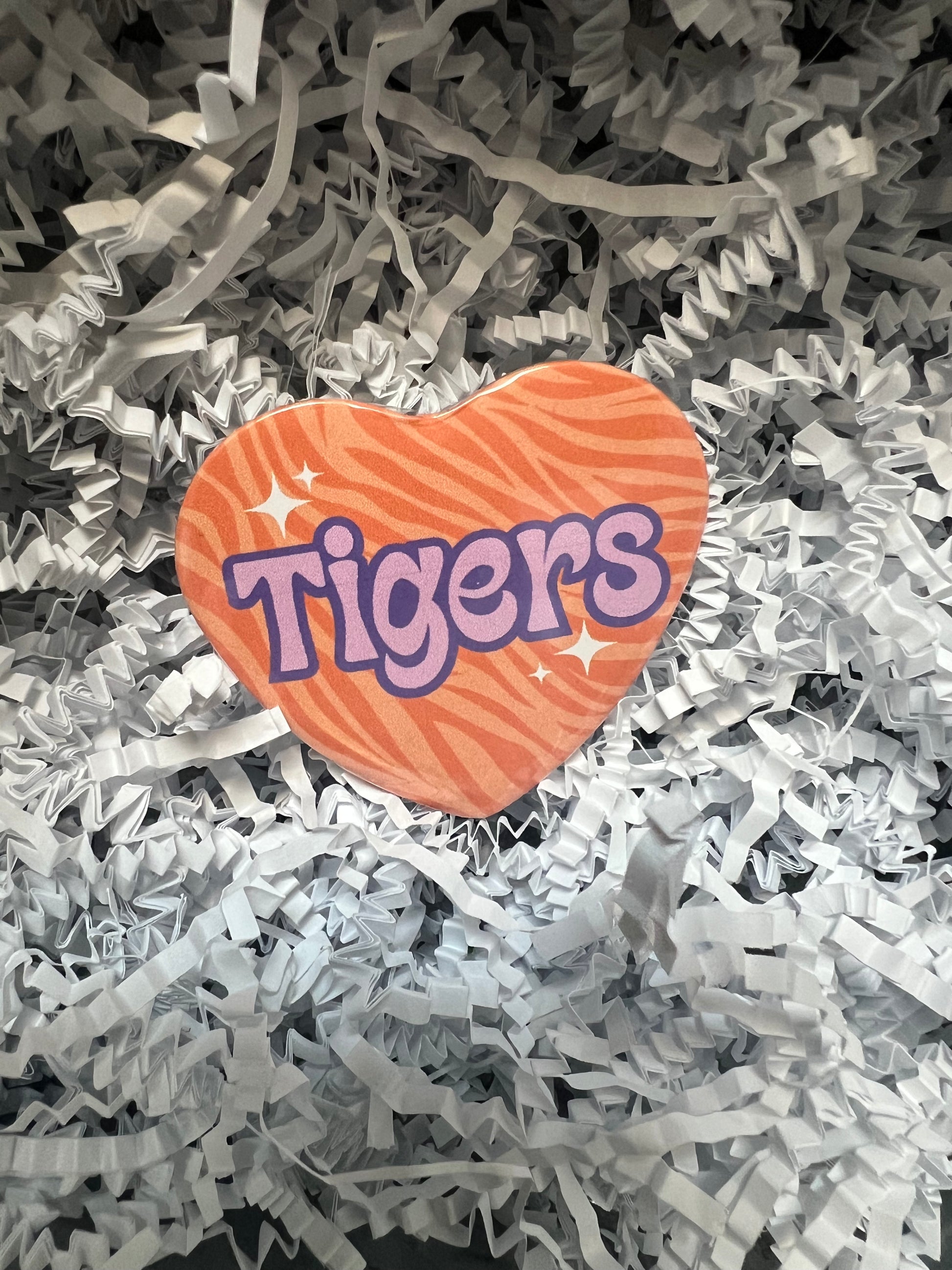 "Tigers" heart-shaped Clemson Tigers button with orange zebra stripes and purple lettering.
