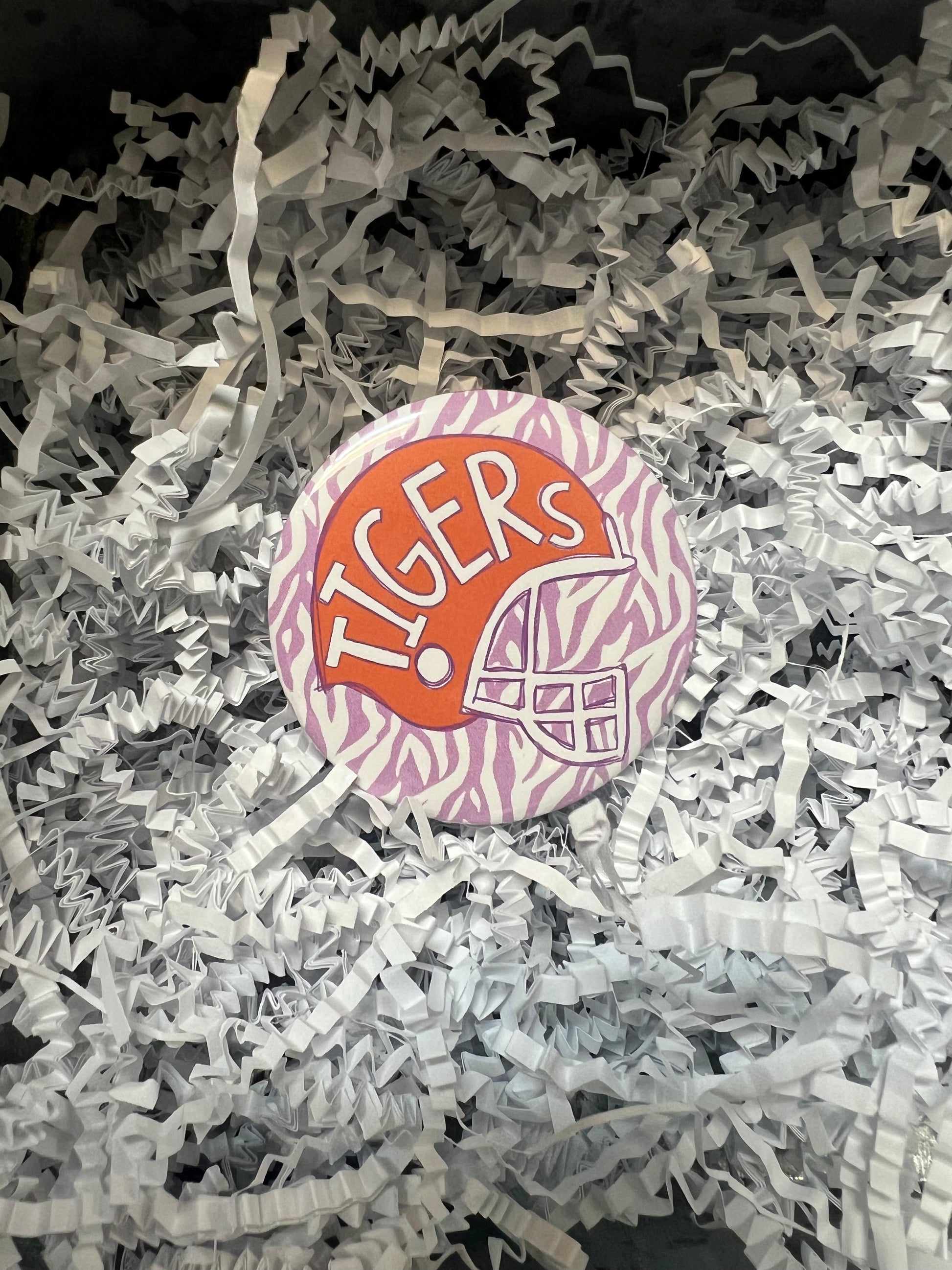 "Tigers" Clemson Tigers button with orange football helmet and purple zebra stripes.