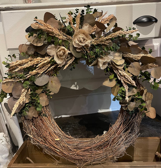 Farmhouse style wreath with eucalyptus and burlap flowers.