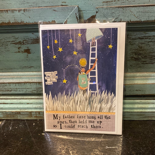 Card with a man on a ladder under a night sky featuring “My father first hung all of the stars, then held me up so I could reach them.”
