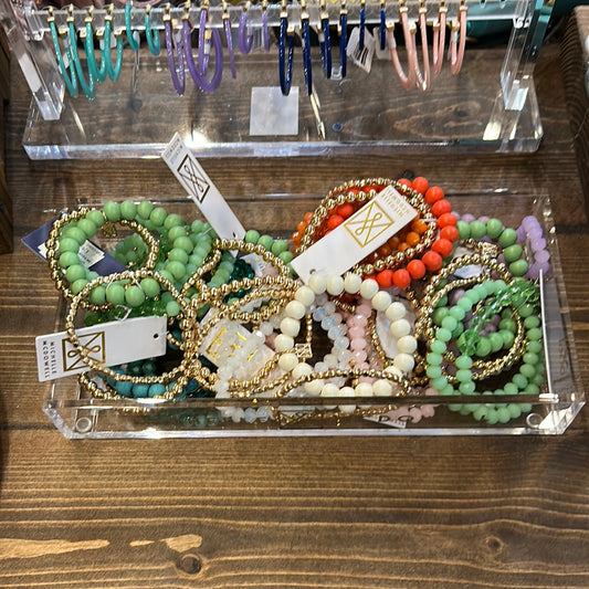 Bracelet stacks in assorted colors.