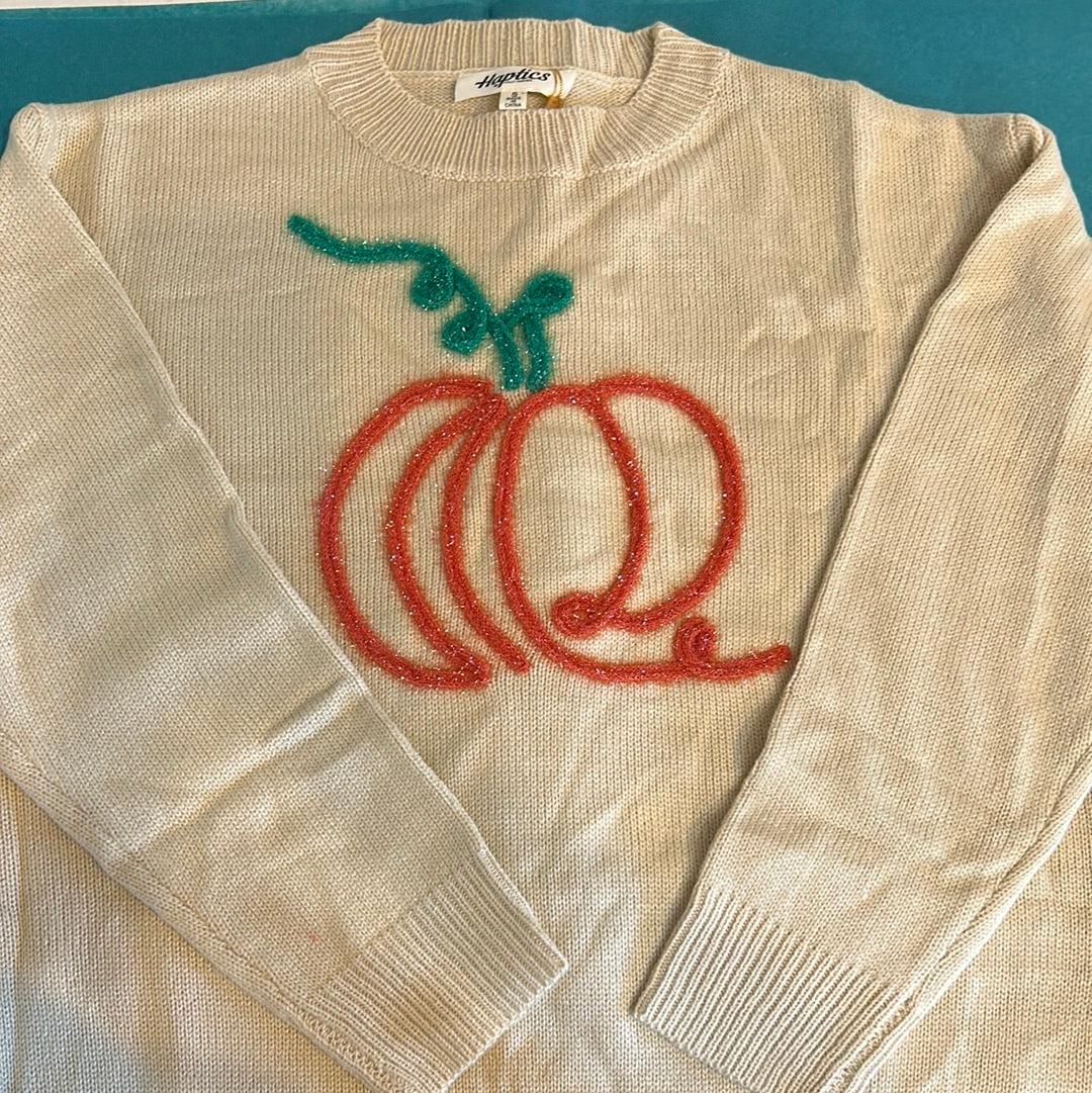 Tan sweater with an orange stitched pumpkin with a green stitched vine.