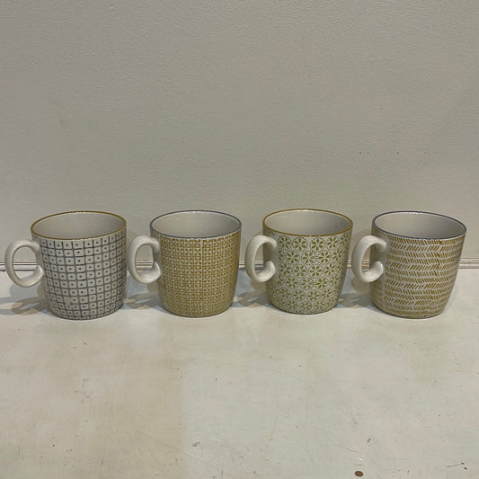 Assorted hand stamped mugs with green hues.
