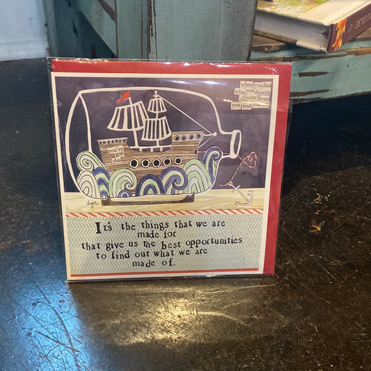Card with a bottled ship displaying “It’s the things that we are made for that give us the best opportunities to find out what we are made of.” 