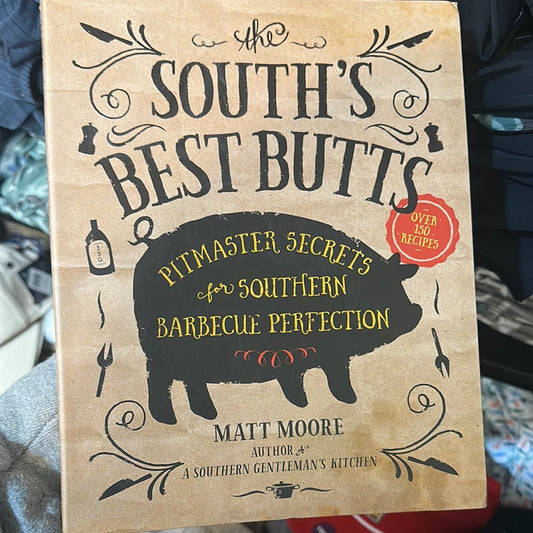 Tan book with a black outline of a pig titling "South's Best Butts".
