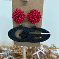 Earrings with red beaded studs and acrylic glittered "G" dangle.