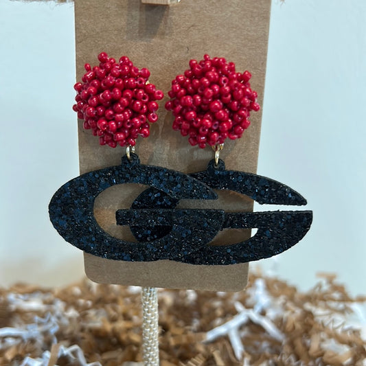 Earrings with red beaded studs and acrylic glittered "G" dangle.