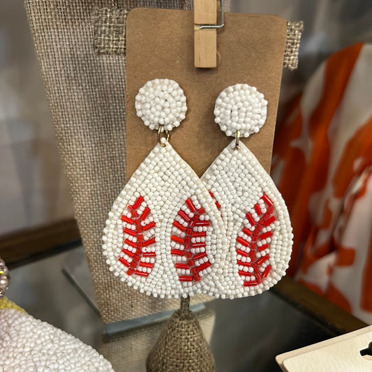 White beaded baseball earrings in a teardrop shape.