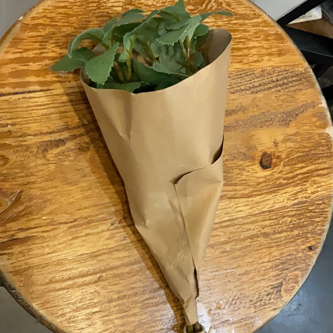 Herb bundle wrapped in brown paper.