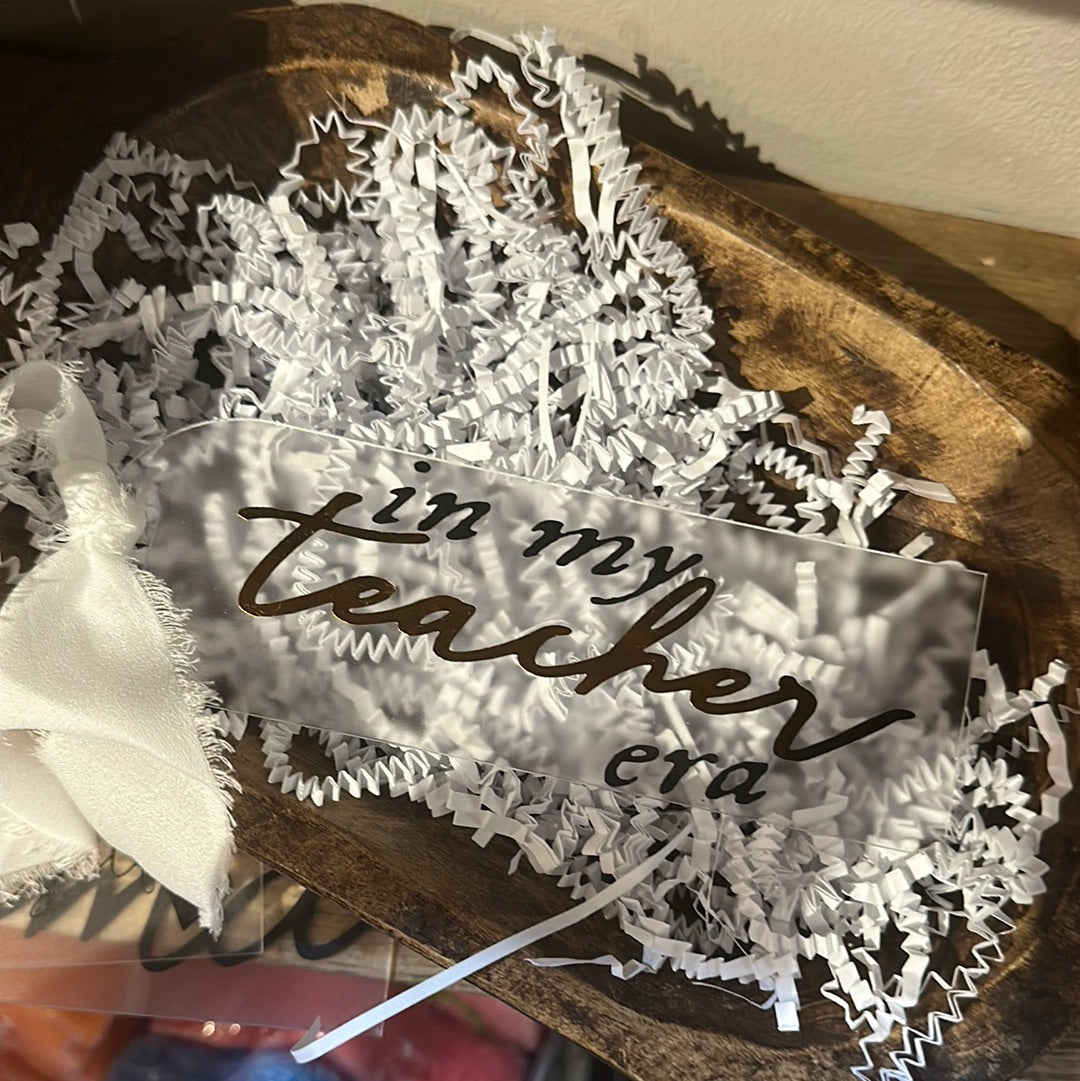 Clear acrylic bookmark with black lettering featuring "in my teacher era".