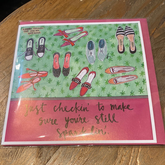 Pink card with shoes featuring “Just checking’ to make sure you’re still sparklin.”